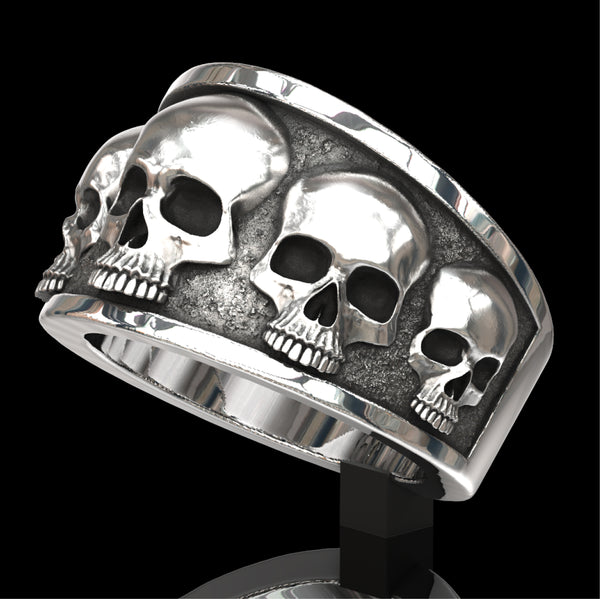 Five skull flared band ring.